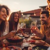 a group of people sitting at a table with food and drinks