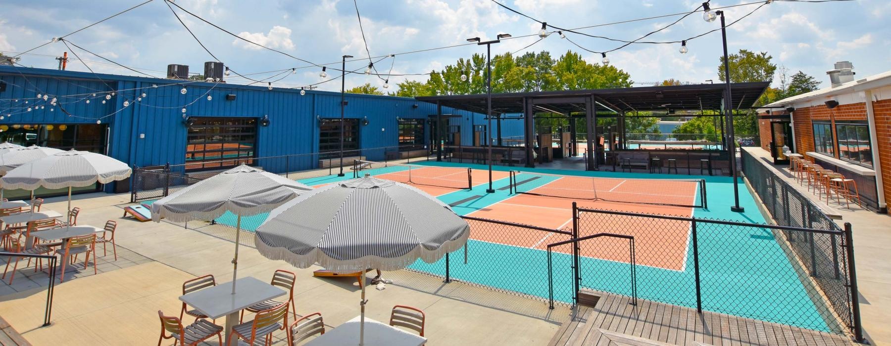 a blue building with tables and chairs